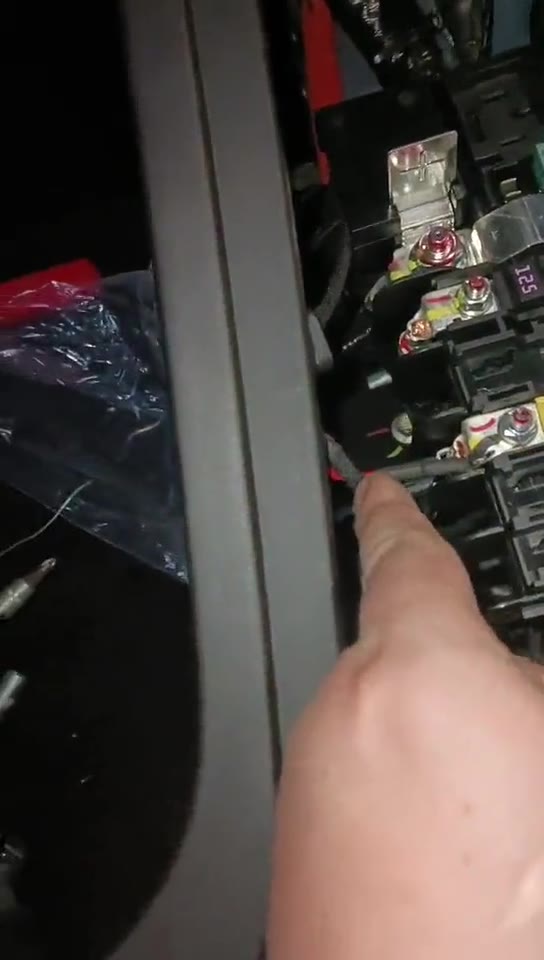 Video still showing the under-bonnet power connection area.